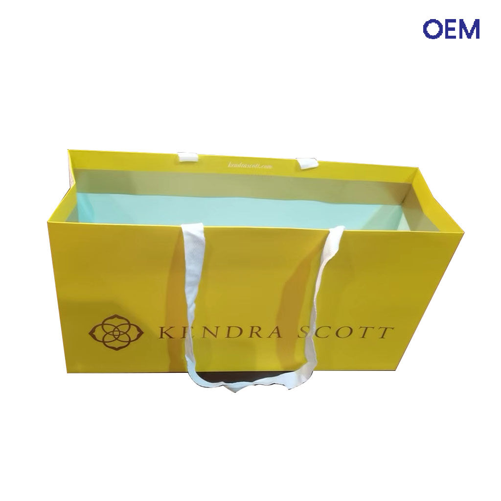 PG34 customized ivory paper bag one color printing + hot gold logo + ribbon handle